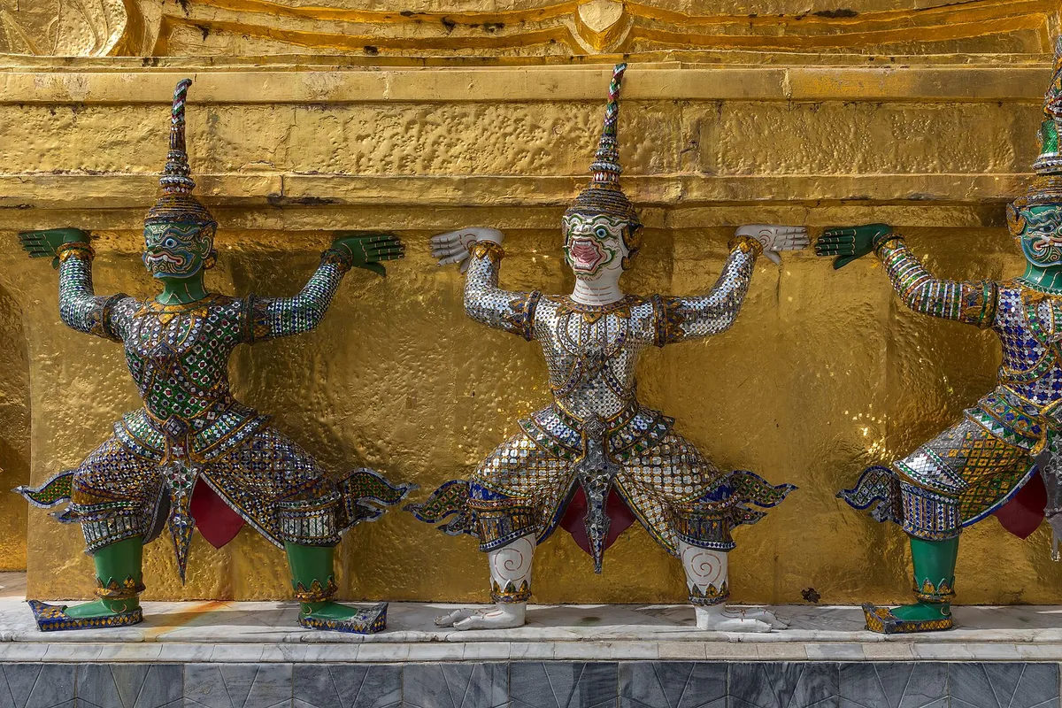 Statues of Yaksha supporting one of the Two Golden Chedi of Wat Phra Kaew, Bangkok, Thailand