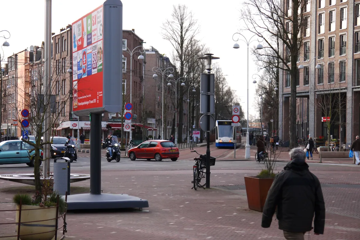 People, walking over the city square Javaplein with election boards and the Javastraat to the left; free street photography Amsterdam by Fons Heijnsbroek, 2015