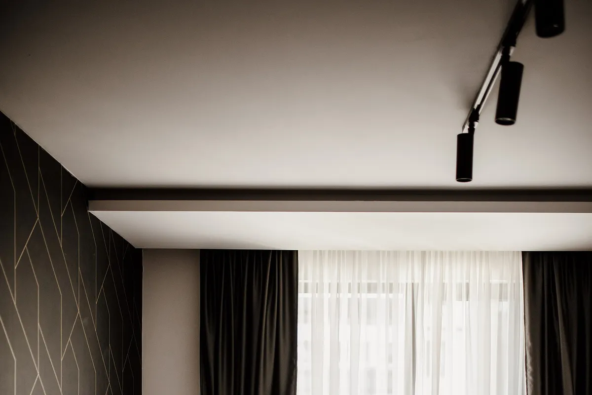 Cozy hotel room with modern furnishings and natural light flowing through the curtains