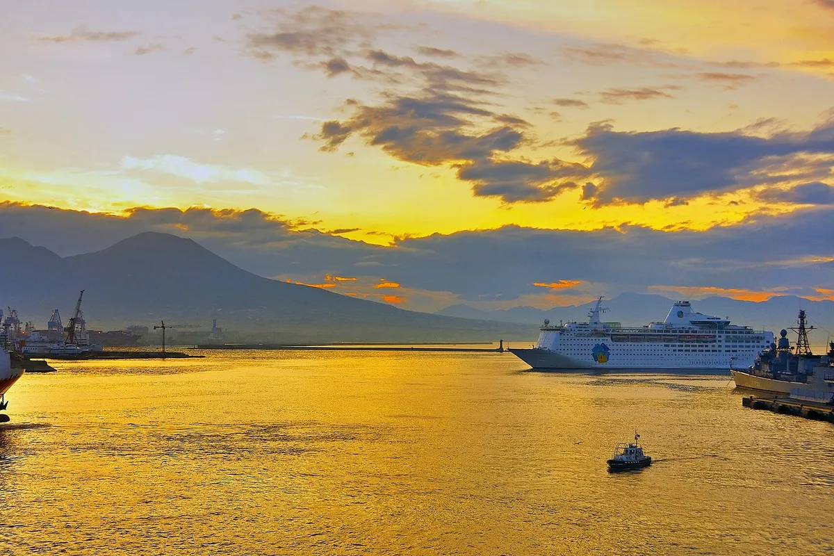 The harbor of Naples and Vesuvius at dawn. Italy